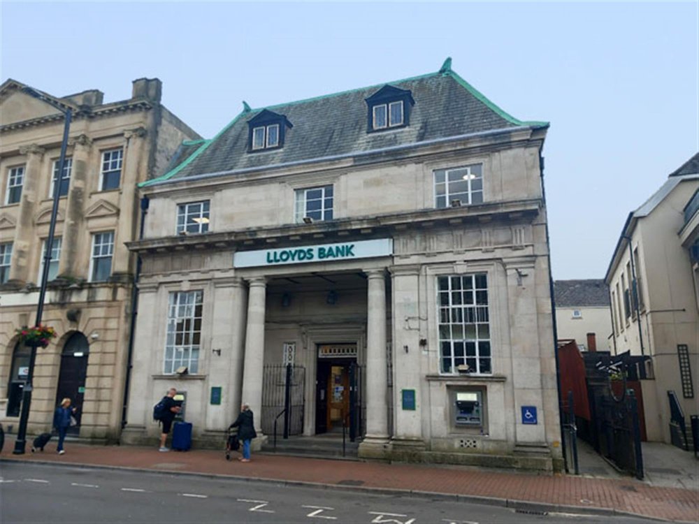 NEATH TOWN CENTRE - PROMINENT AND IMPRESSIVE STONE FRONTED INVESTMENT PROPERTY LET TO HIGH STREET BANK WITH A YIELD OF 9.09%